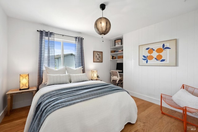 bedroom featuring wood finished floors and baseboards