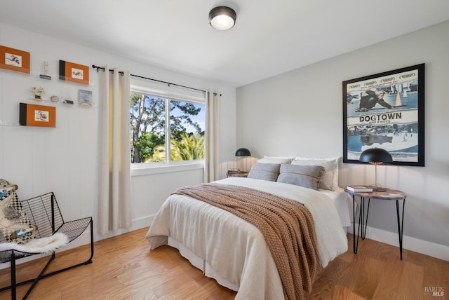 bedroom with light wood-style flooring and baseboards