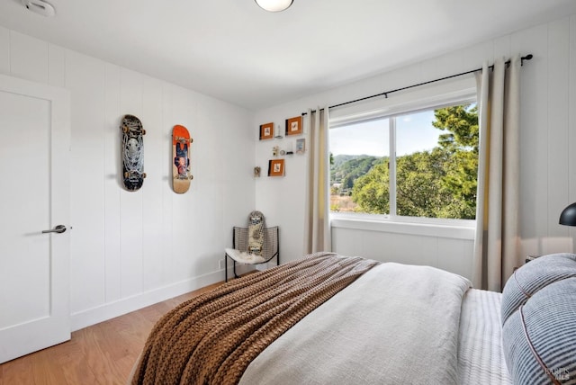 bedroom with light wood-style floors and baseboards