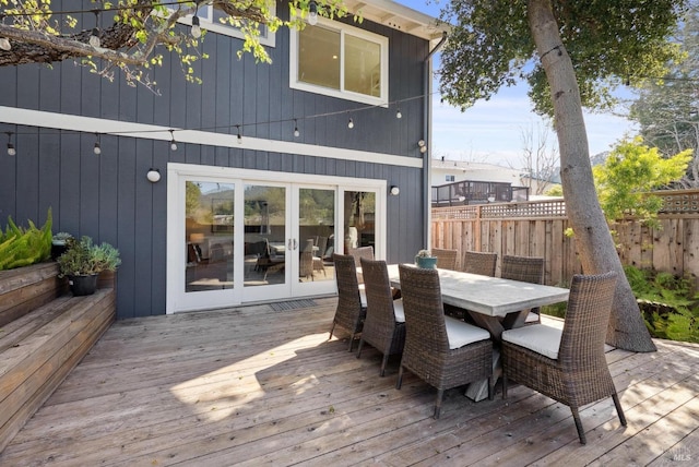 deck featuring fence, french doors, and outdoor dining space