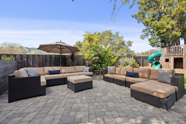 view of patio / terrace with a fenced backyard, an outdoor hangout area, and a playground