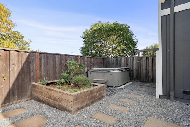 view of patio / terrace with a hot tub and a fenced backyard