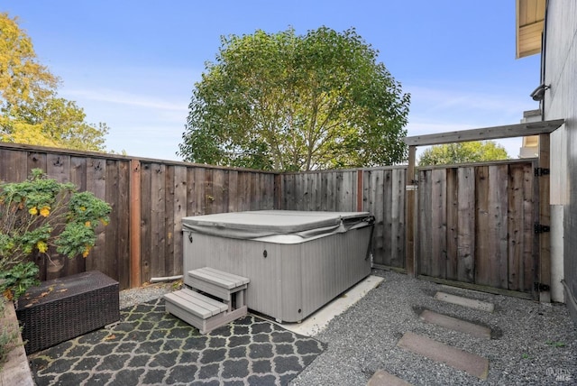 view of patio / terrace with a hot tub and a fenced backyard