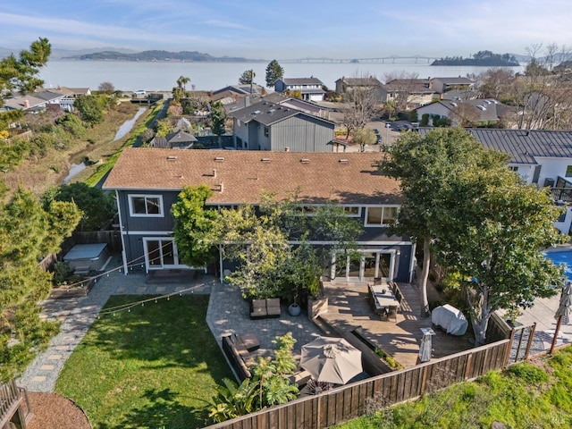 birds eye view of property with a residential view and a water view