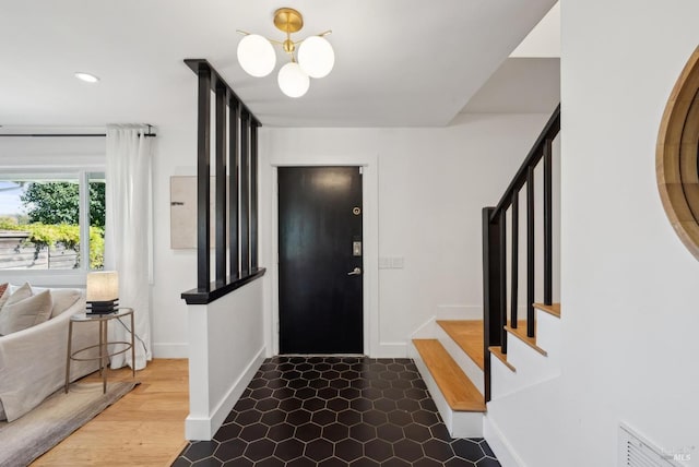 foyer featuring visible vents, baseboards, stairway, a chandelier, and recessed lighting