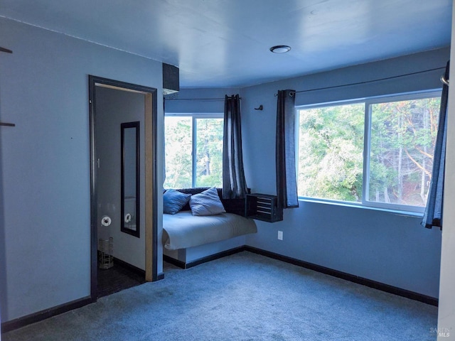 unfurnished bedroom featuring carpet and baseboards