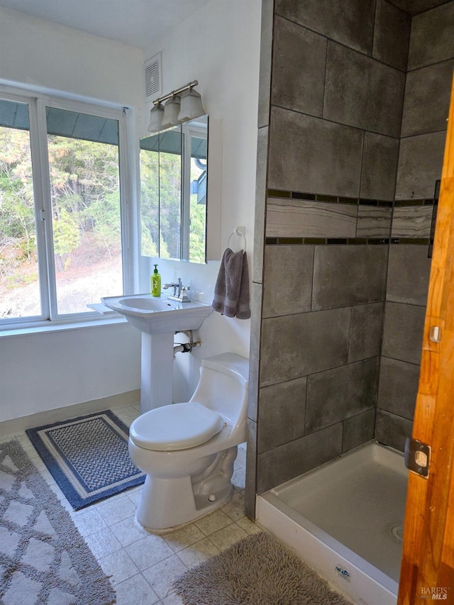 bathroom with tile patterned flooring, visible vents, a shower stall, and toilet