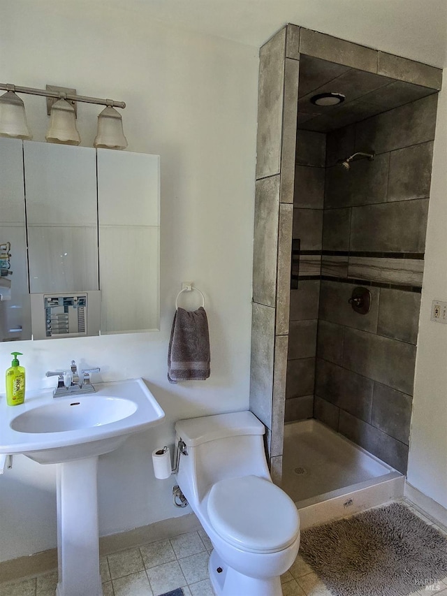 full bath featuring a stall shower, tile patterned flooring, and toilet