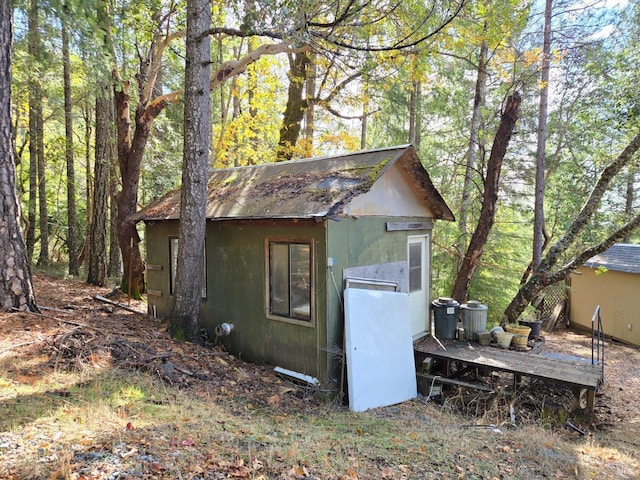 view of outdoor structure with an outdoor structure and a view of trees