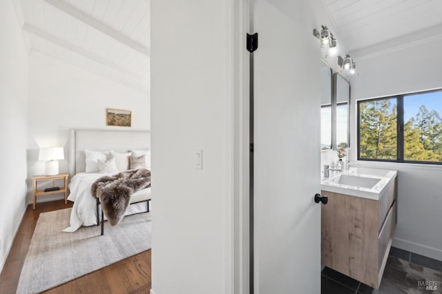 bathroom with vaulted ceiling with beams, wood ceiling, vanity, wood finished floors, and baseboards