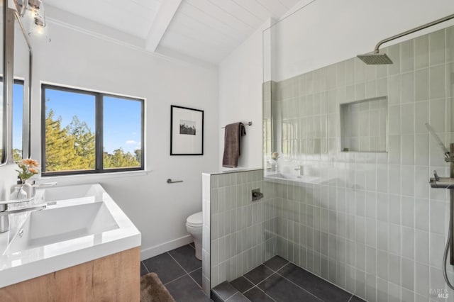 bathroom featuring a walk in shower, toilet, a sink, tile patterned floors, and beamed ceiling