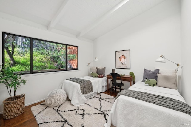 bedroom with vaulted ceiling with beams, baseboards, and wood finished floors