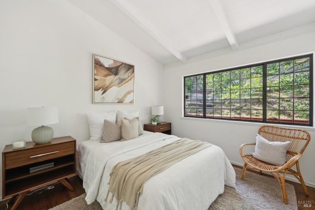 bedroom with vaulted ceiling with beams, multiple windows, wood finished floors, and baseboards