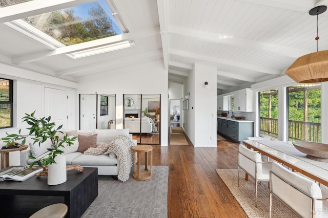 living area with lofted ceiling with skylight and dark wood-type flooring