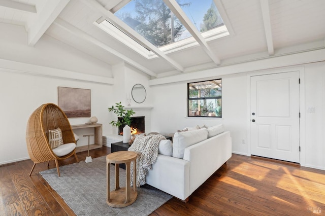 living area featuring a warm lit fireplace, vaulted ceiling with skylight, and dark wood-style flooring