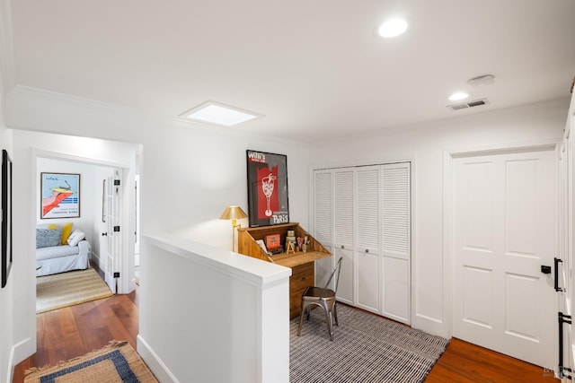 home office with recessed lighting, visible vents, and wood finished floors