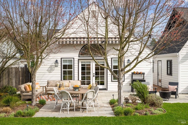 back of house featuring a patio area, fence, an outdoor living space, and french doors