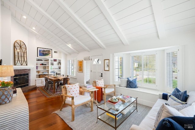 living room with a fireplace, lofted ceiling with beams, wood ceiling, wood finished floors, and baseboards