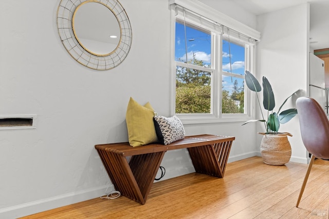 living area with baseboards and light wood finished floors