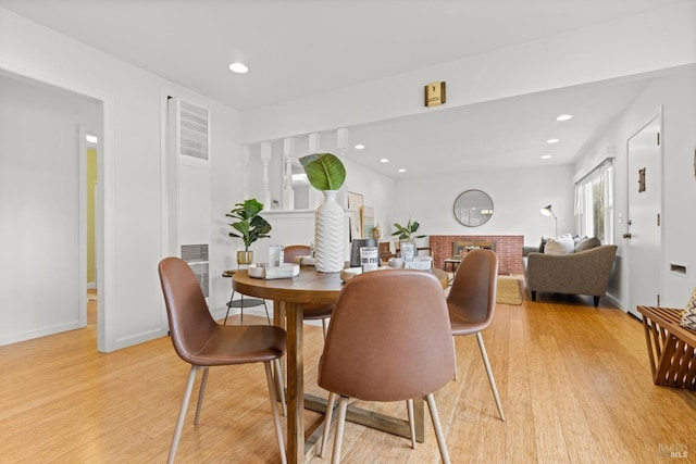 dining room with recessed lighting, light wood-type flooring, and baseboards