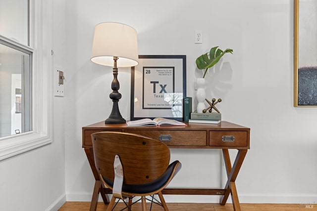 home office with light wood finished floors and baseboards