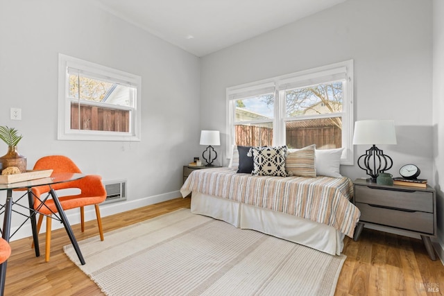 bedroom featuring baseboards and wood finished floors