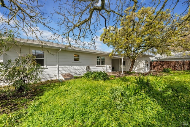 rear view of property with a lawn