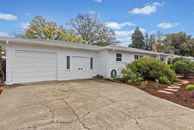 view of side of home with a garage and driveway