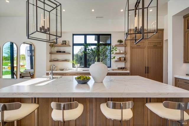 2350 Big Ranch Rd, Napa, CA 94558 - kitchen featuring open shelves, a chandelier, brown cabinetry, a large island with sink, and recessed lighting