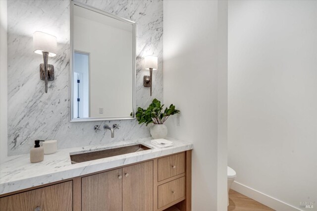 2350 Big Ranch Rd, Napa, CA 94558 - half bathroom with toilet, vanity, baseboards, and wood finished floors