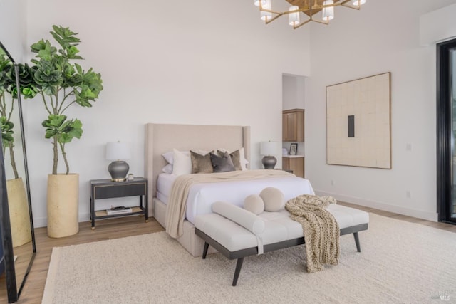 2350 Big Ranch Rd, Napa, CA 94558 - bedroom featuring light wood finished floors, a chandelier, baseboards, and a towering ceiling