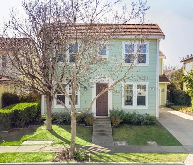 view of front of property with a front lawn and concrete driveway