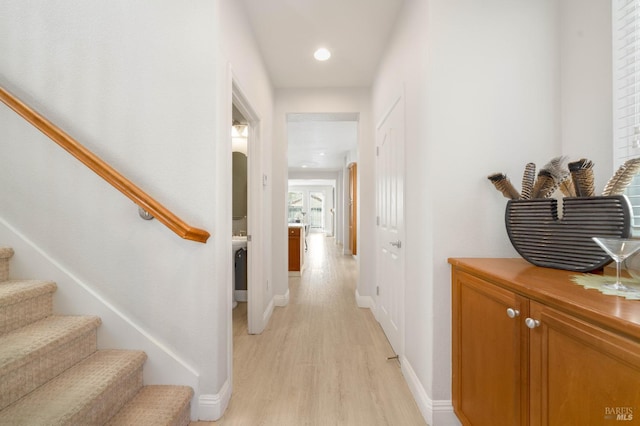 hall featuring light wood finished floors, stairway, recessed lighting, and baseboards