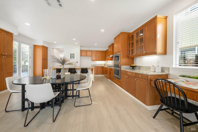 dining room with light wood-type flooring, visible vents, and recessed lighting