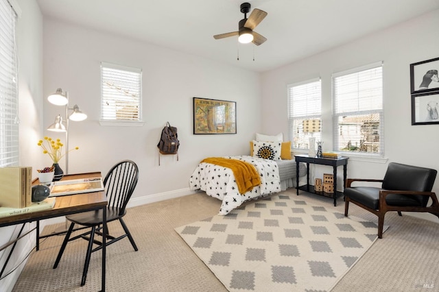 bedroom featuring light carpet and baseboards