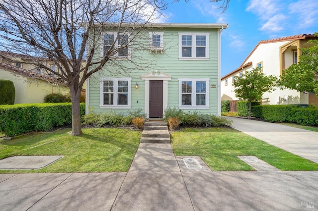 colonial-style house with a front lawn