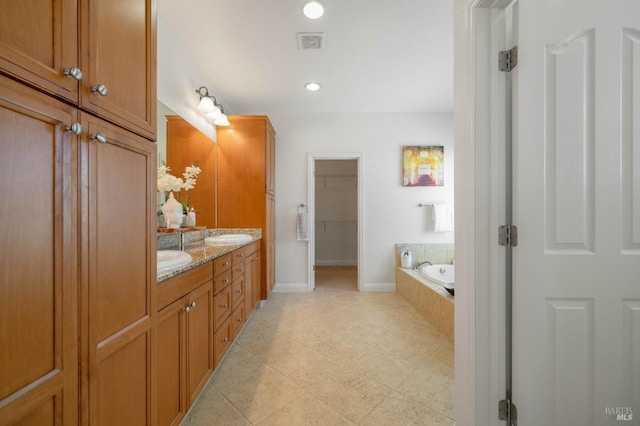 full bathroom featuring double vanity, tiled bath, baseboards, visible vents, and tile patterned flooring