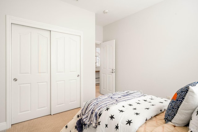 carpeted bedroom with a closet