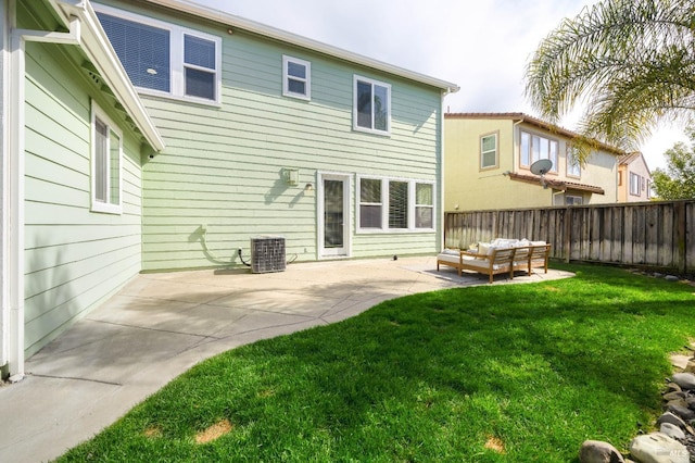 rear view of property with central AC unit, a lawn, fence, a patio area, and an outdoor living space