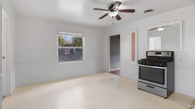 kitchen with light floors, baseboards, visible vents, and stainless steel range with gas stovetop