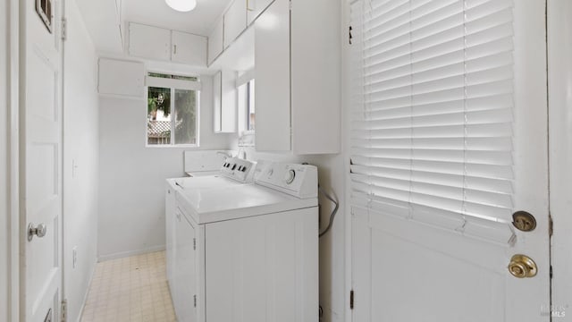 clothes washing area featuring washing machine and dryer, laundry area, baseboards, and light floors