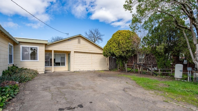 view of front of house featuring fence and aphalt driveway