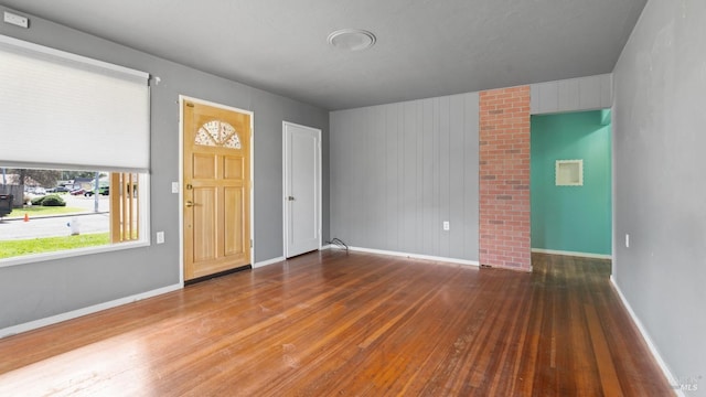 foyer with hardwood / wood-style floors and baseboards