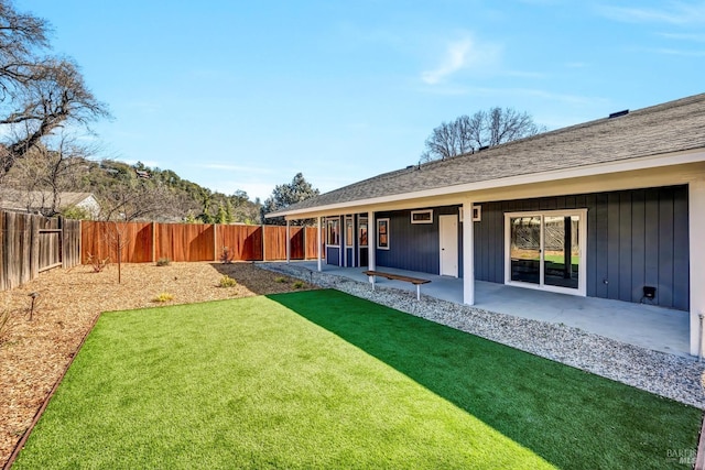 view of yard with a fenced backyard and a patio