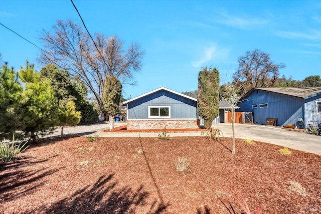 view of front of property with concrete driveway and brick siding