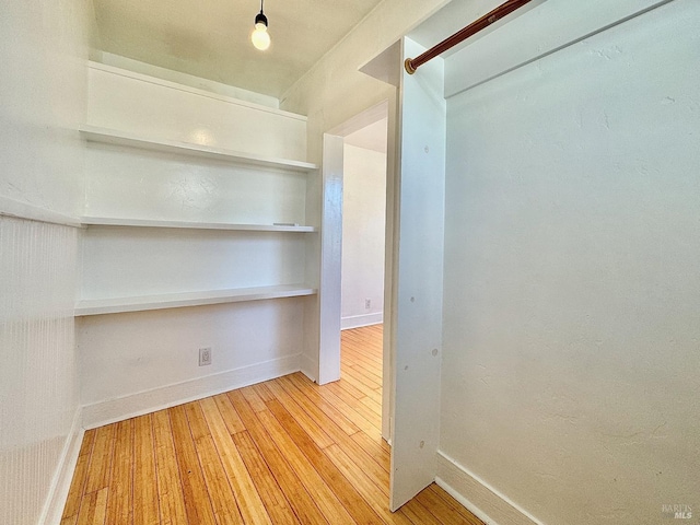 interior space with wood-type flooring and baseboards