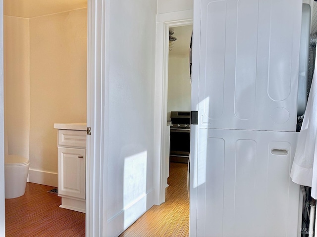 corridor with wood finished floors and baseboards