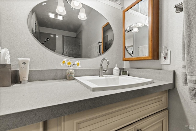 bathroom with a textured wall and vanity