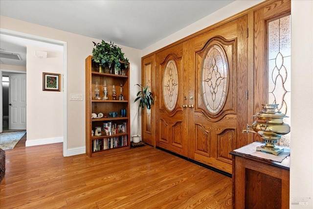 entryway featuring light wood finished floors and baseboards