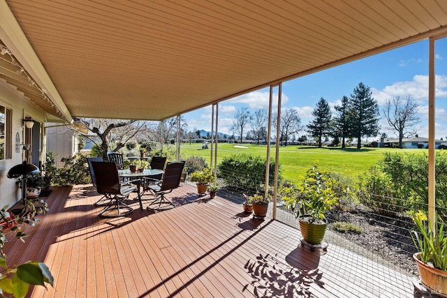 deck featuring a lawn and outdoor dining space